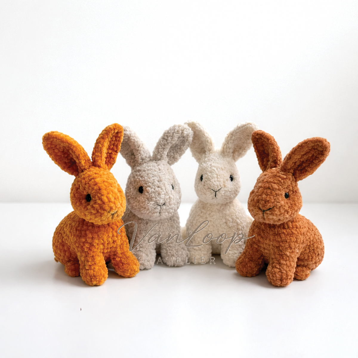 Four plush crochet baby rabbits in mustard, beige, cream and brown yarn