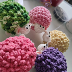 Five fluffy sheep amigurumi crochet color variations in green pink yellow and purple