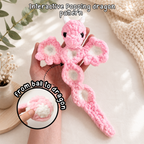 Interactive pink popping dragon crochet pattern, shown unfolded with five popping sections and ball transformation inset